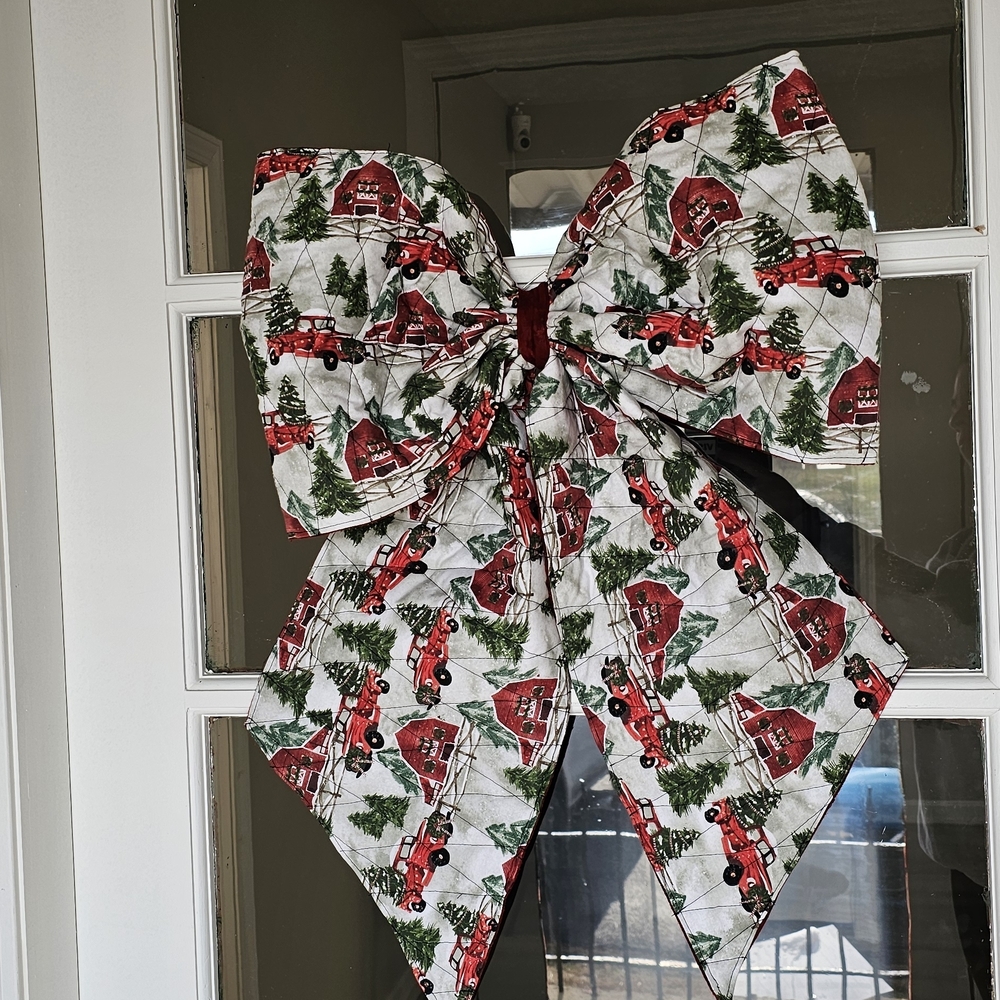 Festive Holiday Bow with Red Trucks and Green Trees